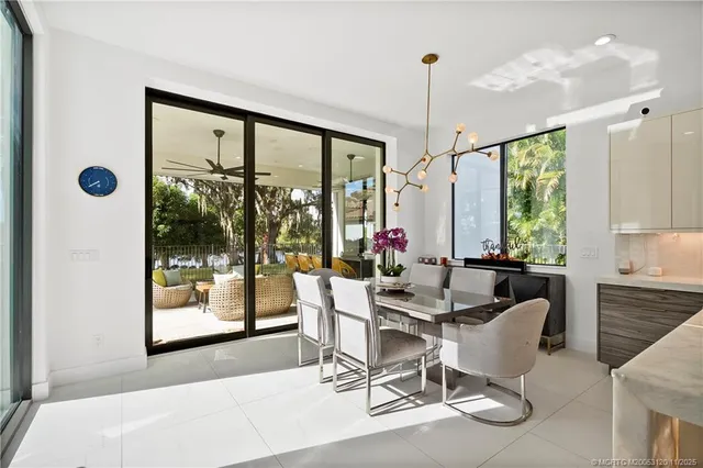 a dining room with furniture wooden floor livingroom and chandelier