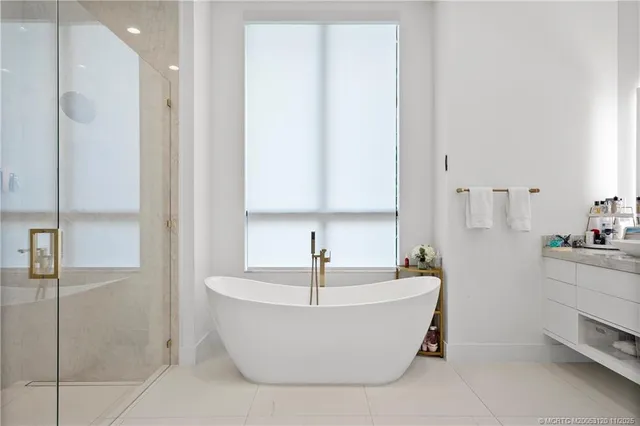 a bathroom with a bathtub and shower