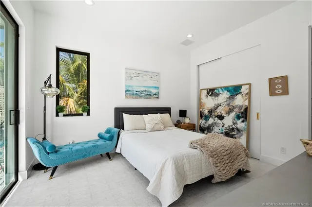 a bedroom with bed and glass window