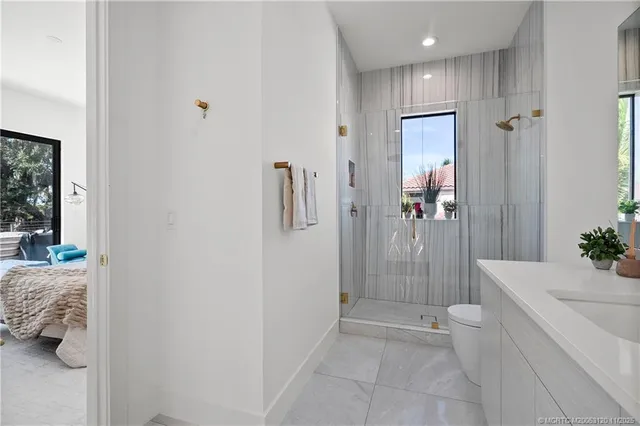 a kitchen with stainless steel appliances kitchen island granite countertop a refrigerator a stove a sink and a stove