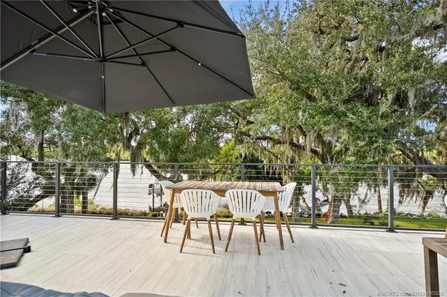 a view of a house with backyard porch and sitting area