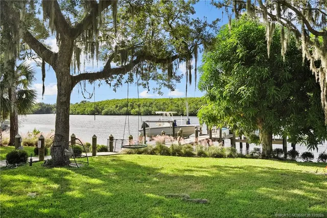 an aerial view of a house with a lake view