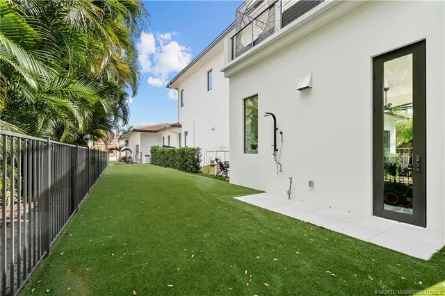 an aerial view of residential houses with outdoor space and ocean view