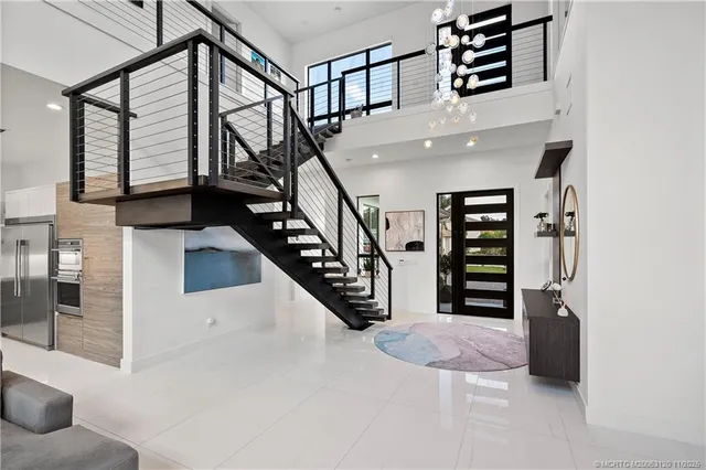 a living room with furniture kitchen view and a wooden floor