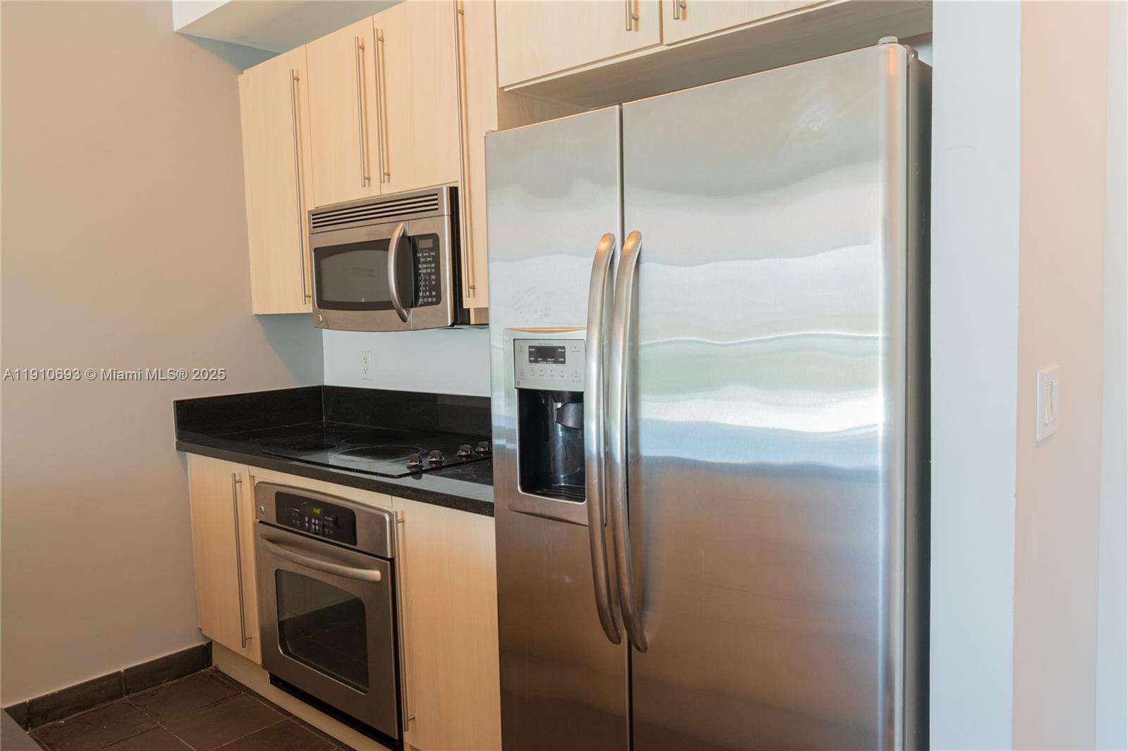 79 Southwest 12th Street, Unit 1002S Miami, FL 33130 - Photo 13 of 22 a kitchen with a refrigerator stove and microwave