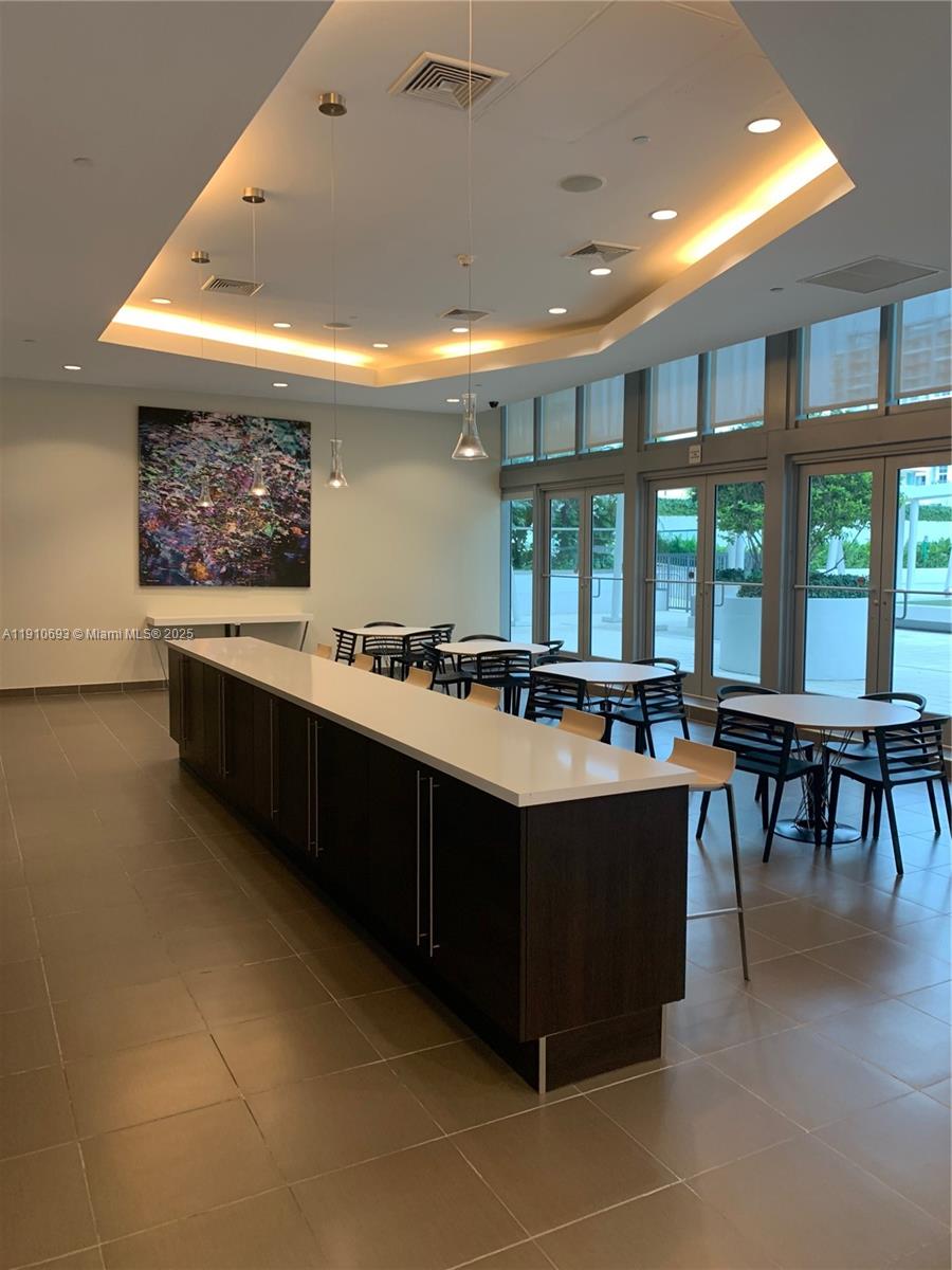 79 Southwest 12th Street, Unit 1002S Miami, FL 33130 - Photo 15 of 22 a kitchen with stainless steel appliances granite countertop a sink and a stove