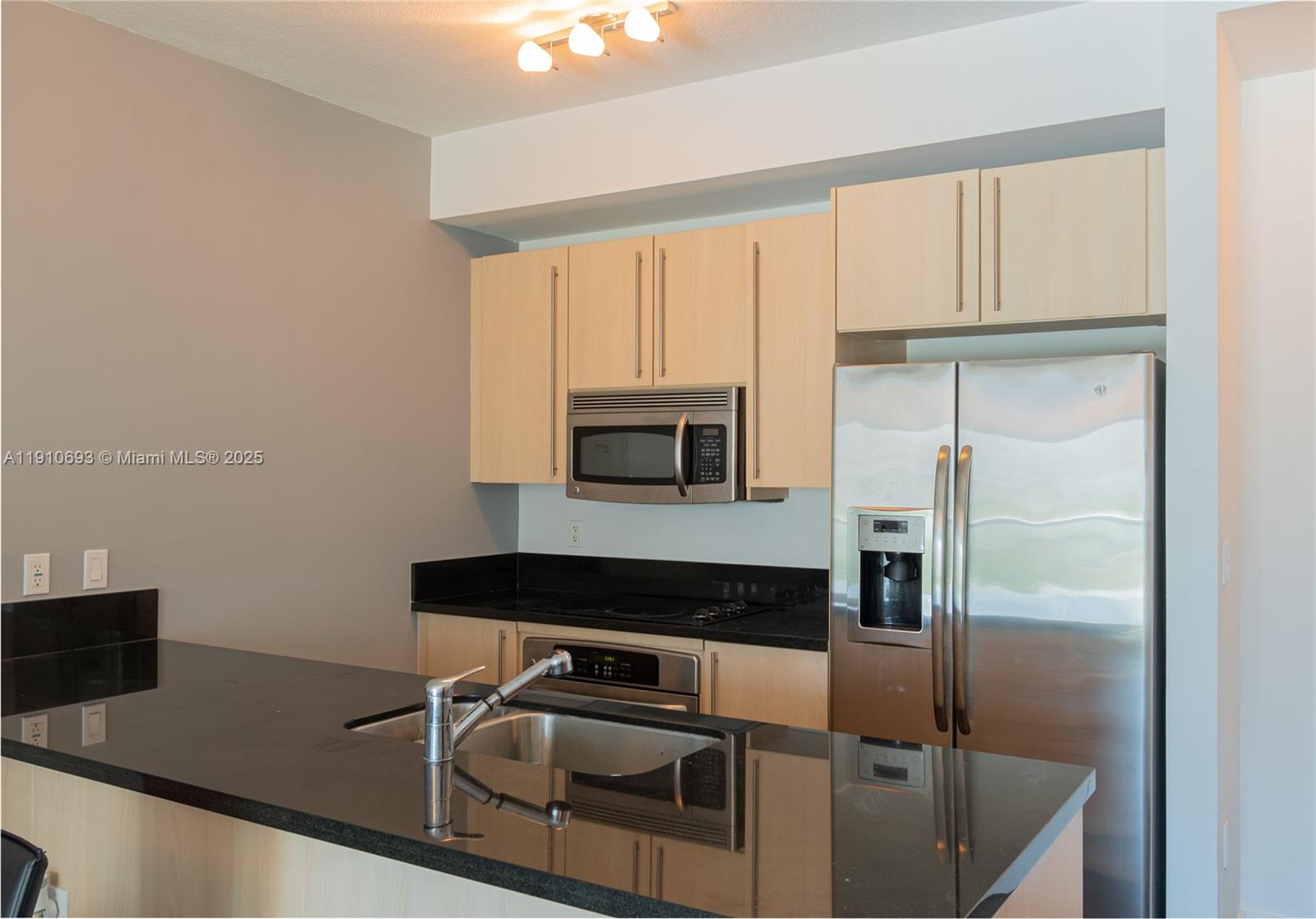 79 Southwest 12th Street, Unit 1002S Miami, FL 33130 - Photo 2 of 22 a kitchen with white cabinets and a refrigerator