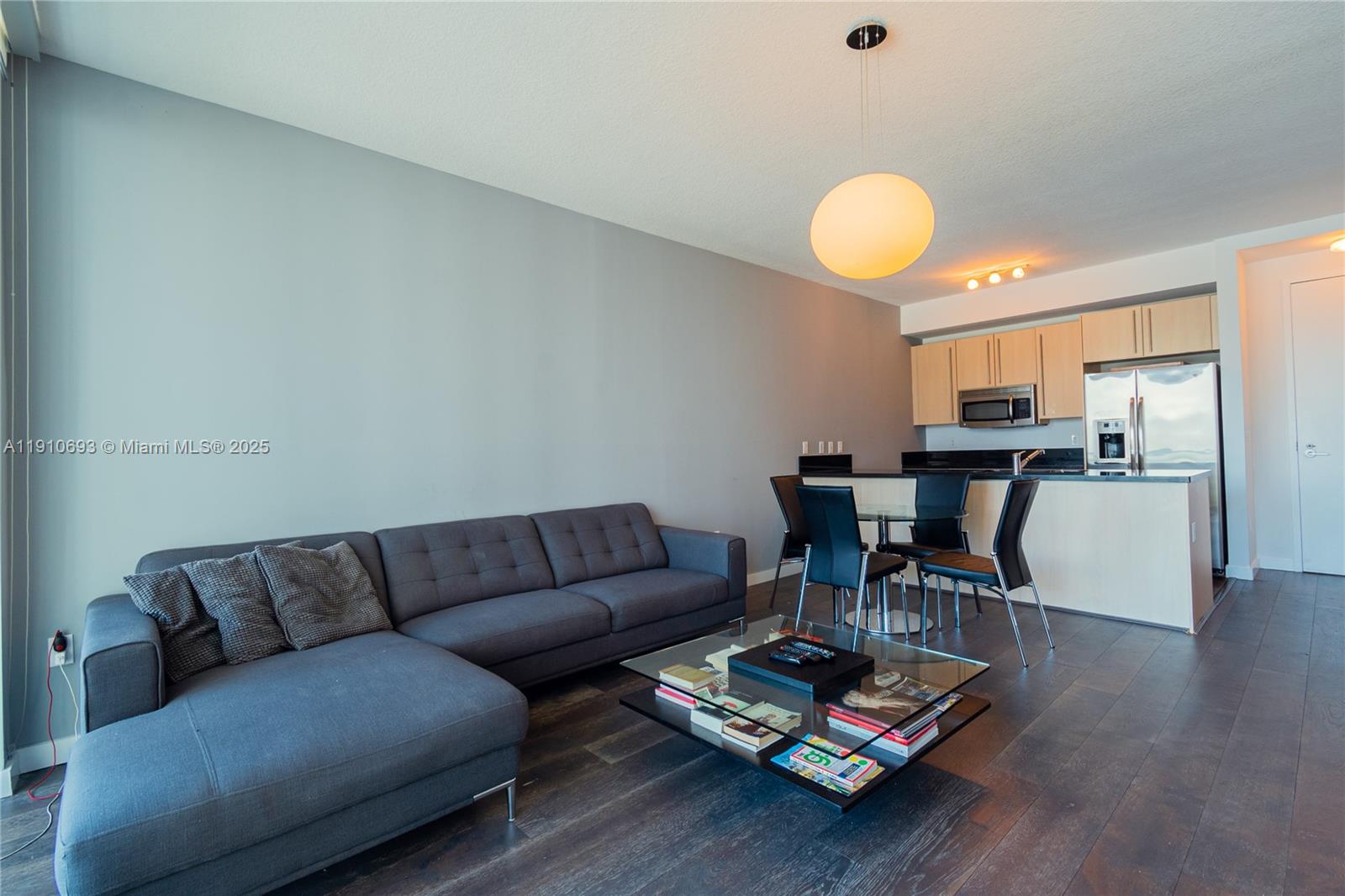 79 Southwest 12th Street, Unit 1002S Miami, FL 33130 - Photo 3 of 22 a living room with furniture and kitchen view