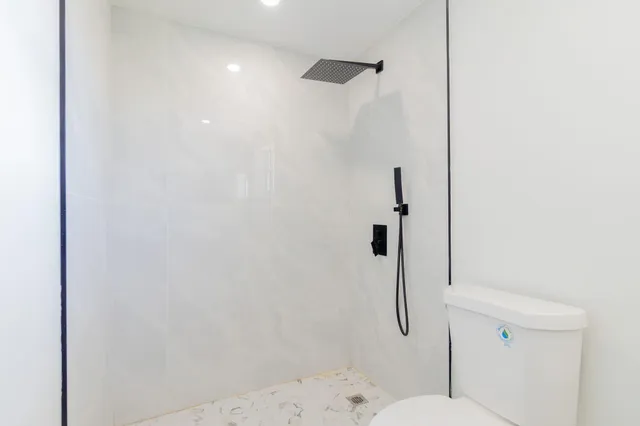 a bathroom with a shower toilet and a shower