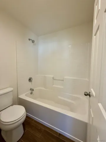 a bathroom with a bathtub and toilet