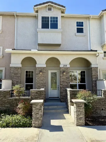 a front view of a house with outdoor seating