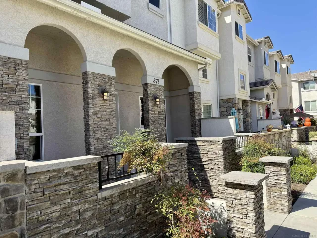 a front view of a house with outdoor seating