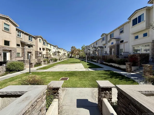 a view of a house with backyard and sitting area
