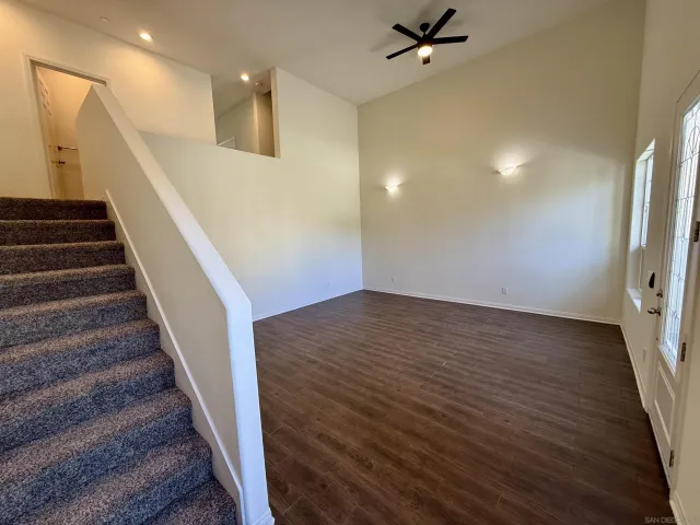 wooden floor in an empty room with a staircase