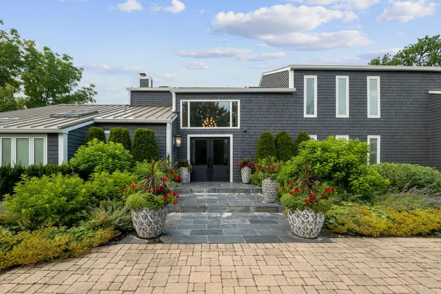 a front view of a house with a garden and yard