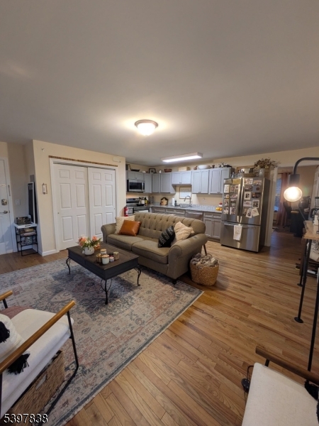 a living room with furniture and wooden floor