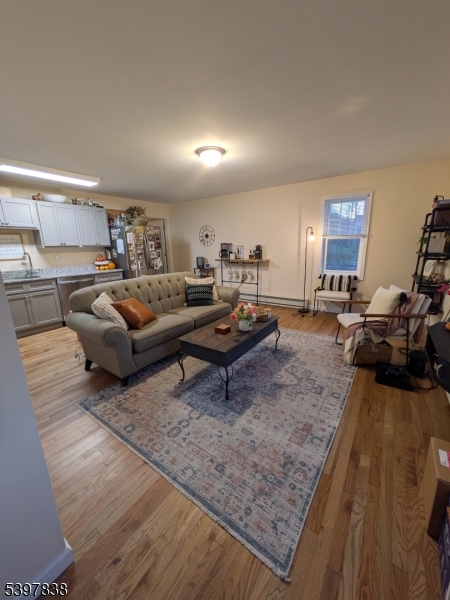 55 Gingerbread Castle Road Hamburg, NJ 07419 - Photo 2 of 7 a living room with furniture and a wooden floor