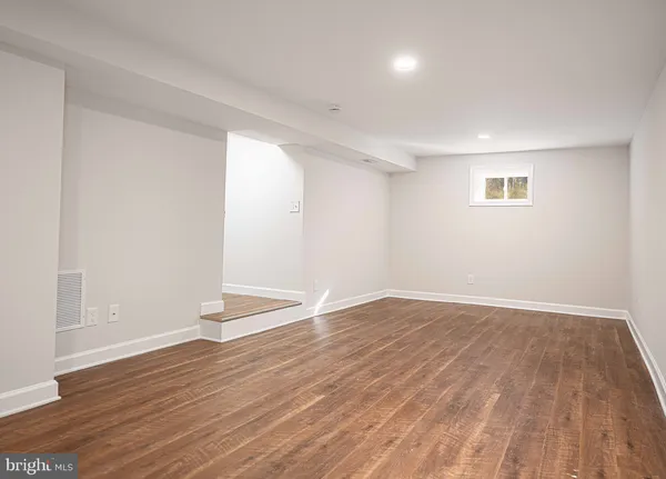 a view of an empty room and wooden floor