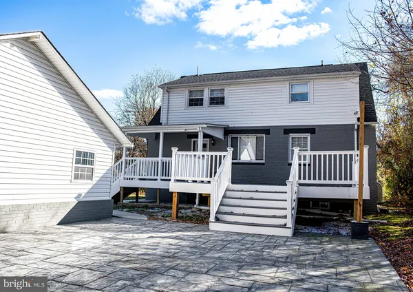 a view of a house with a wooden fence