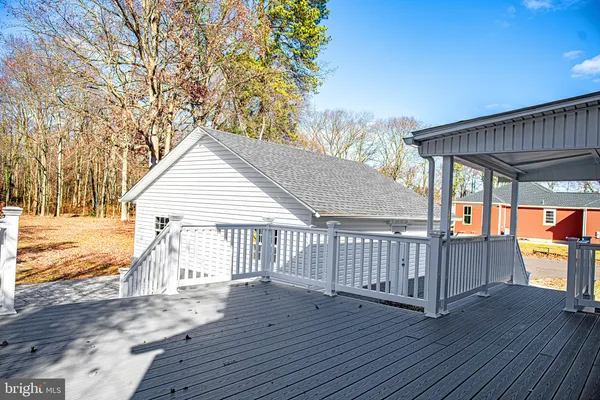 a view of a house with wooden floor next to a yard