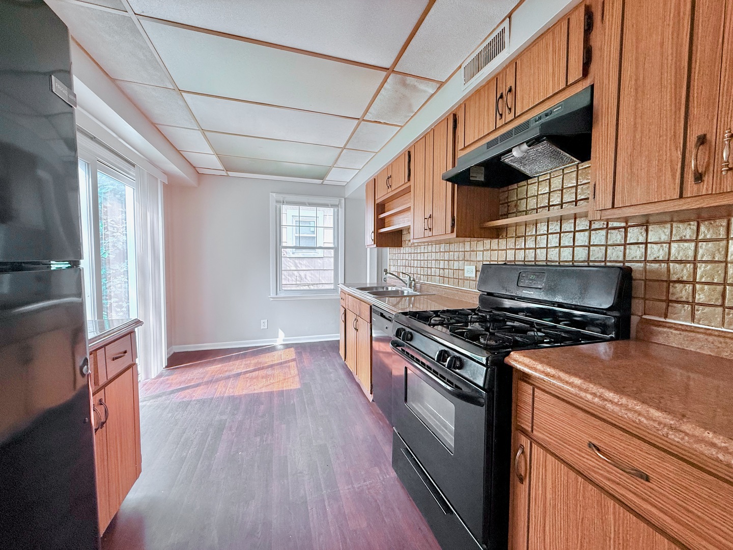 16784 Crane Avenue Hazel Crest, IL 60429 - Photo 15 of 24 a kitchen with granite countertop wooden floors and stainless steel appliances