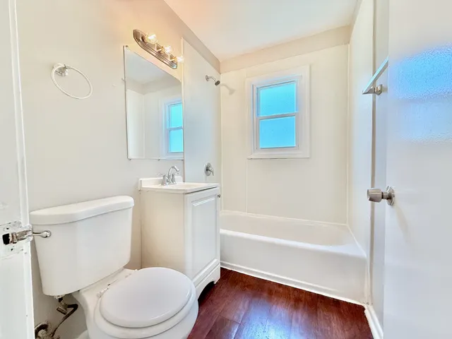 a white toilet sitting next to a bath tub