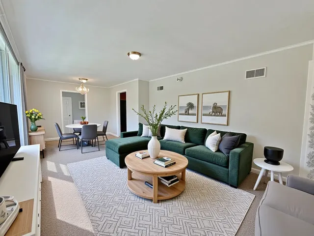a living room with furniture and a chandelier