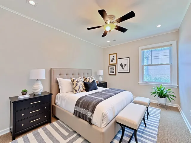 a bedroom with a bed and a potted plant