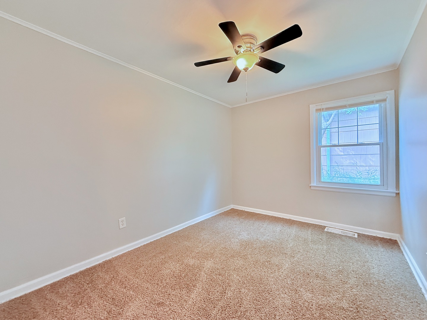 16784 Crane Avenue Hazel Crest, IL 60429 - Photo 10 of 24 an empty room with a window and a fan