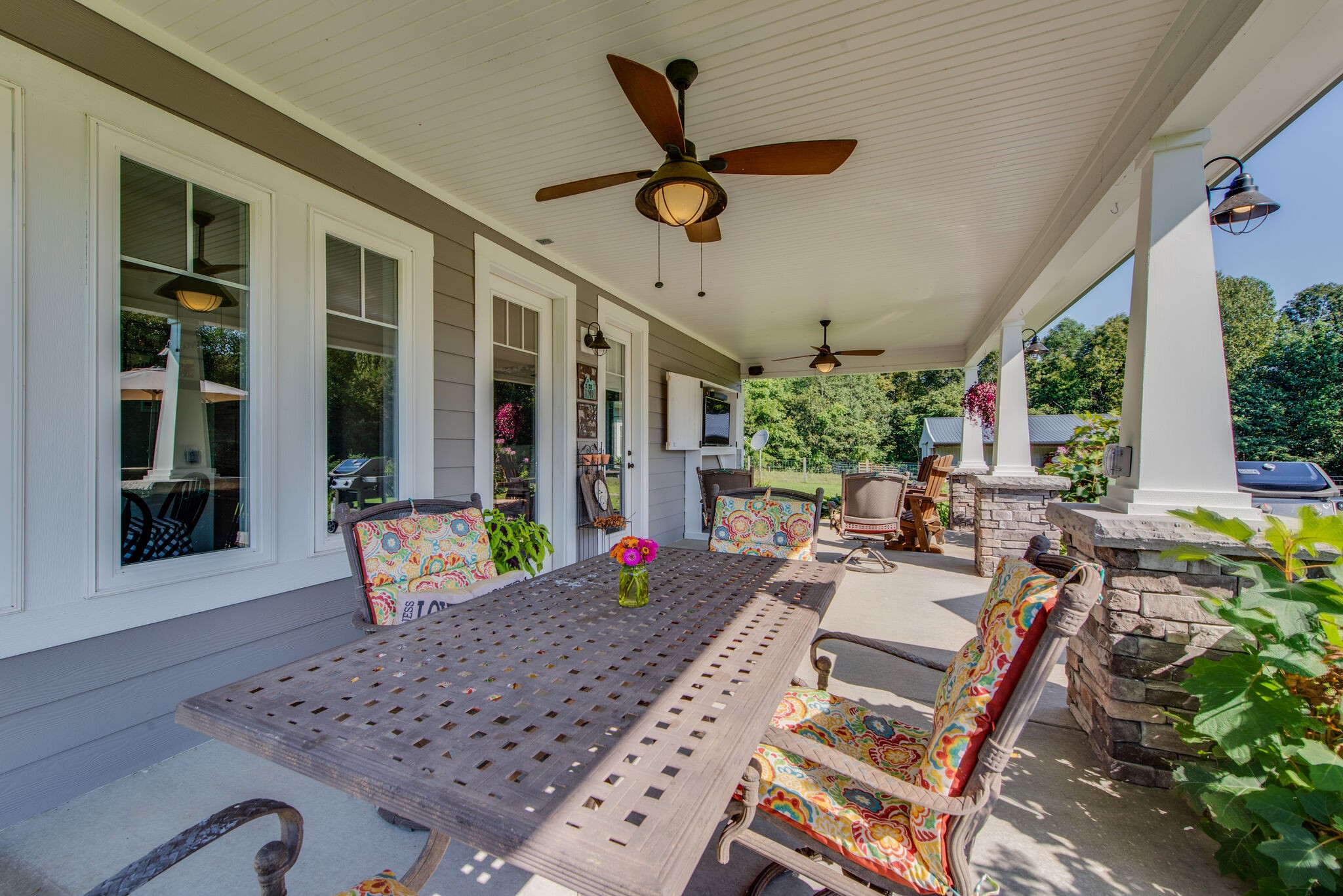 5062 Cathey Ridge Road Manchester, TN 37355 - Photo 35 of 47 a view of a patio with table and chairs potted plants with wooden floor