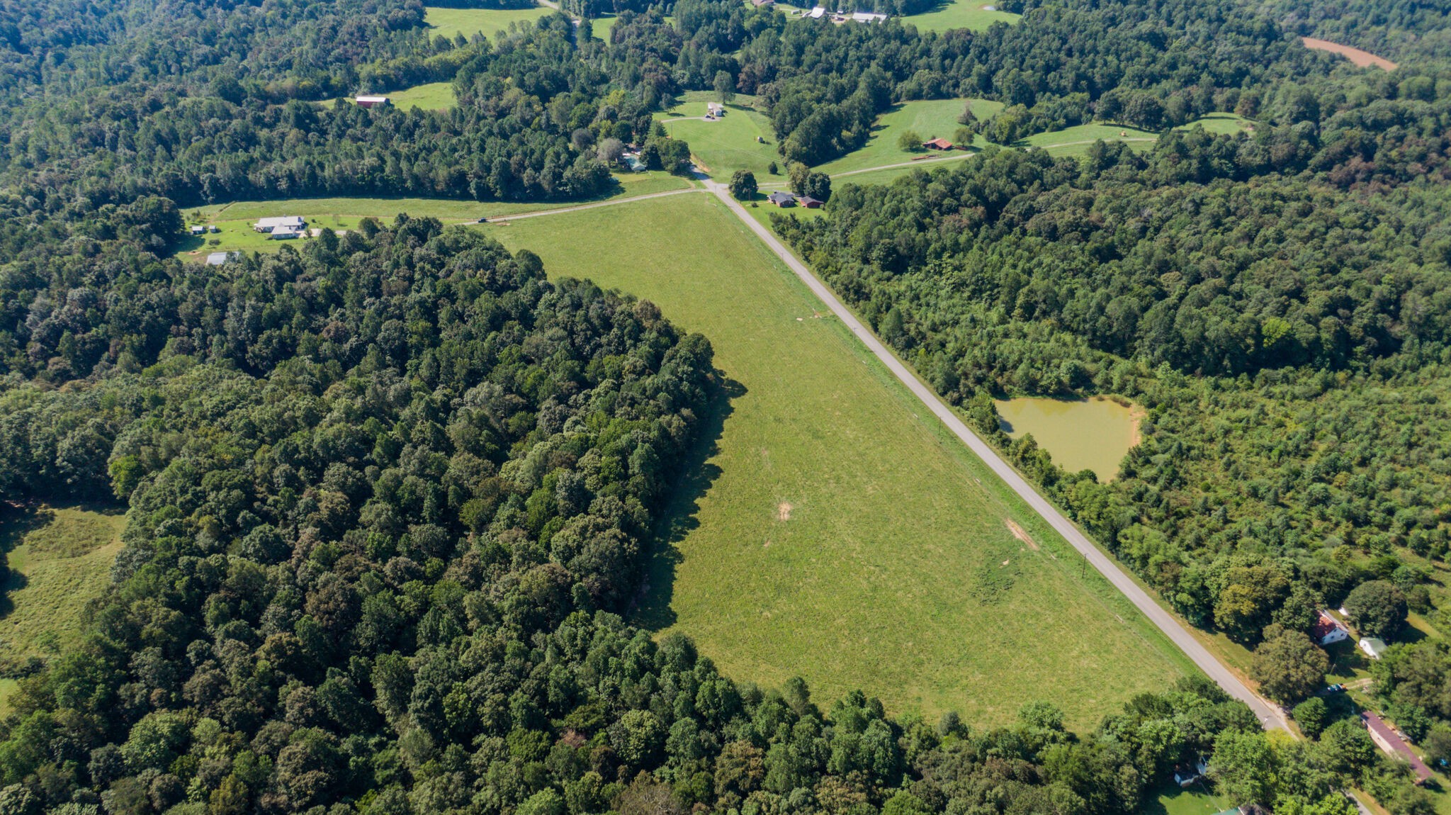 5062 Cathey Ridge Road Manchester, TN 37355 - Photo 39 of 47 a view of a lake with a yard and large trees