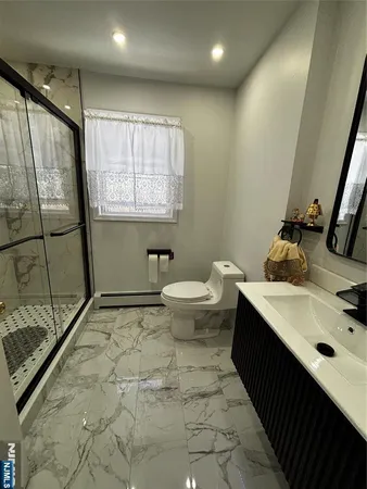 a bathroom with a sink toilet and shower
