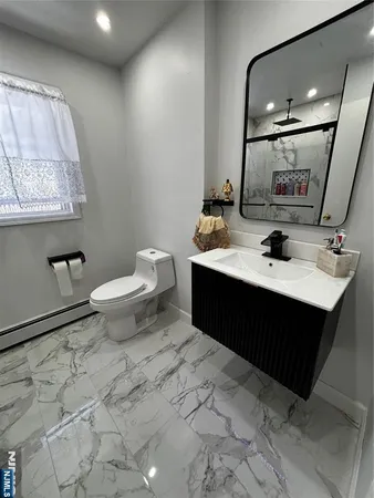 a bathroom with a sink toilet and mirror