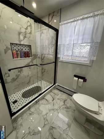a bathroom with a toilet a sink and a shower