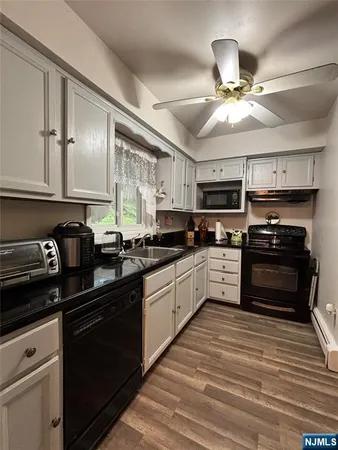 a kitchen with a sink cabinets and window
