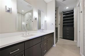 5921 Hiline Road, Unit 1203 Austin, TX 78734 - Photo 23 of 34 An elegant double vanity flows seamlessly into a spacious custom walk-in closet.