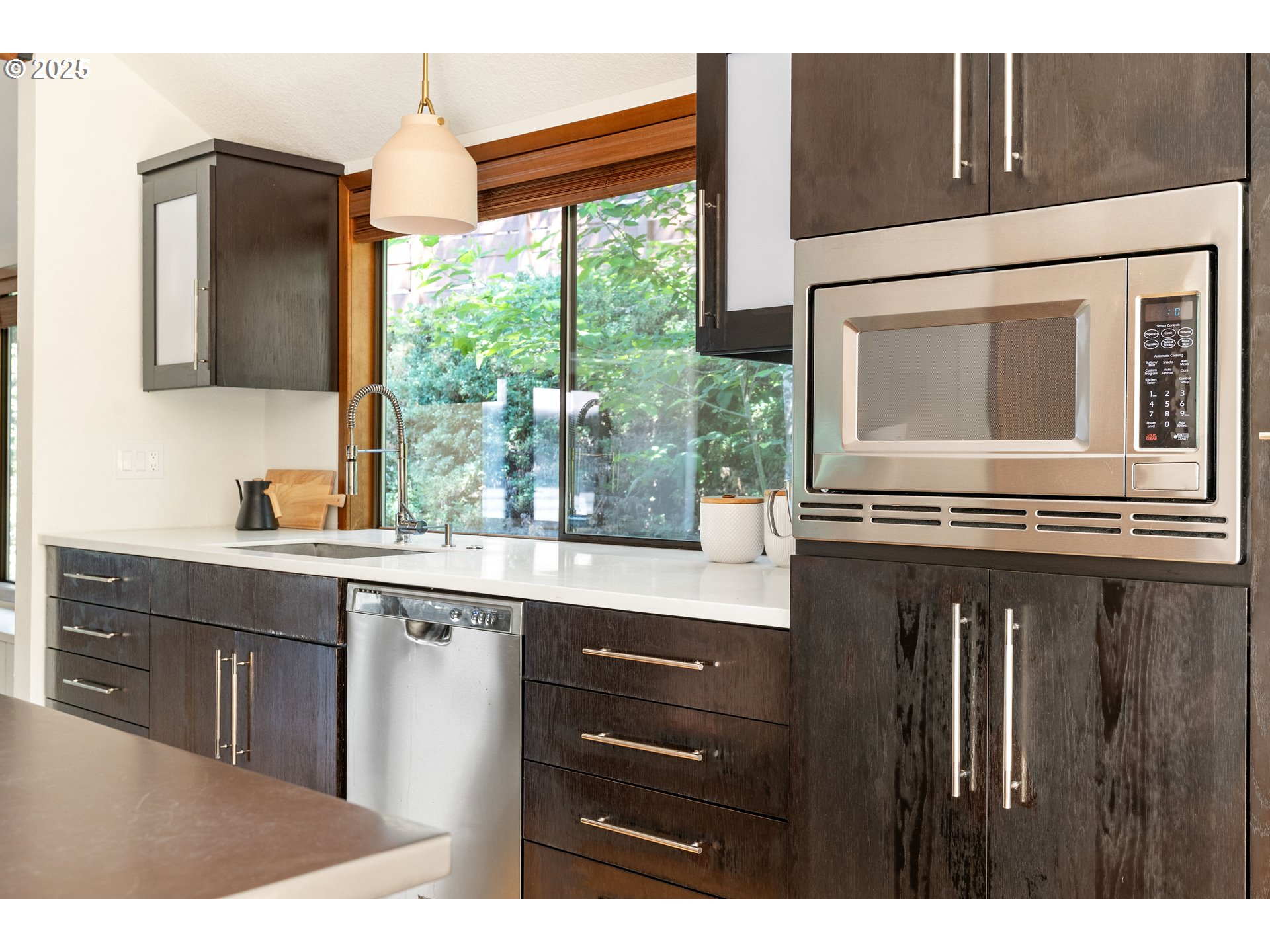 511 Southwest Colony Drive Portland, OR 97219 - Photo 11 of 46 a kitchen with a sink window and cabinets
