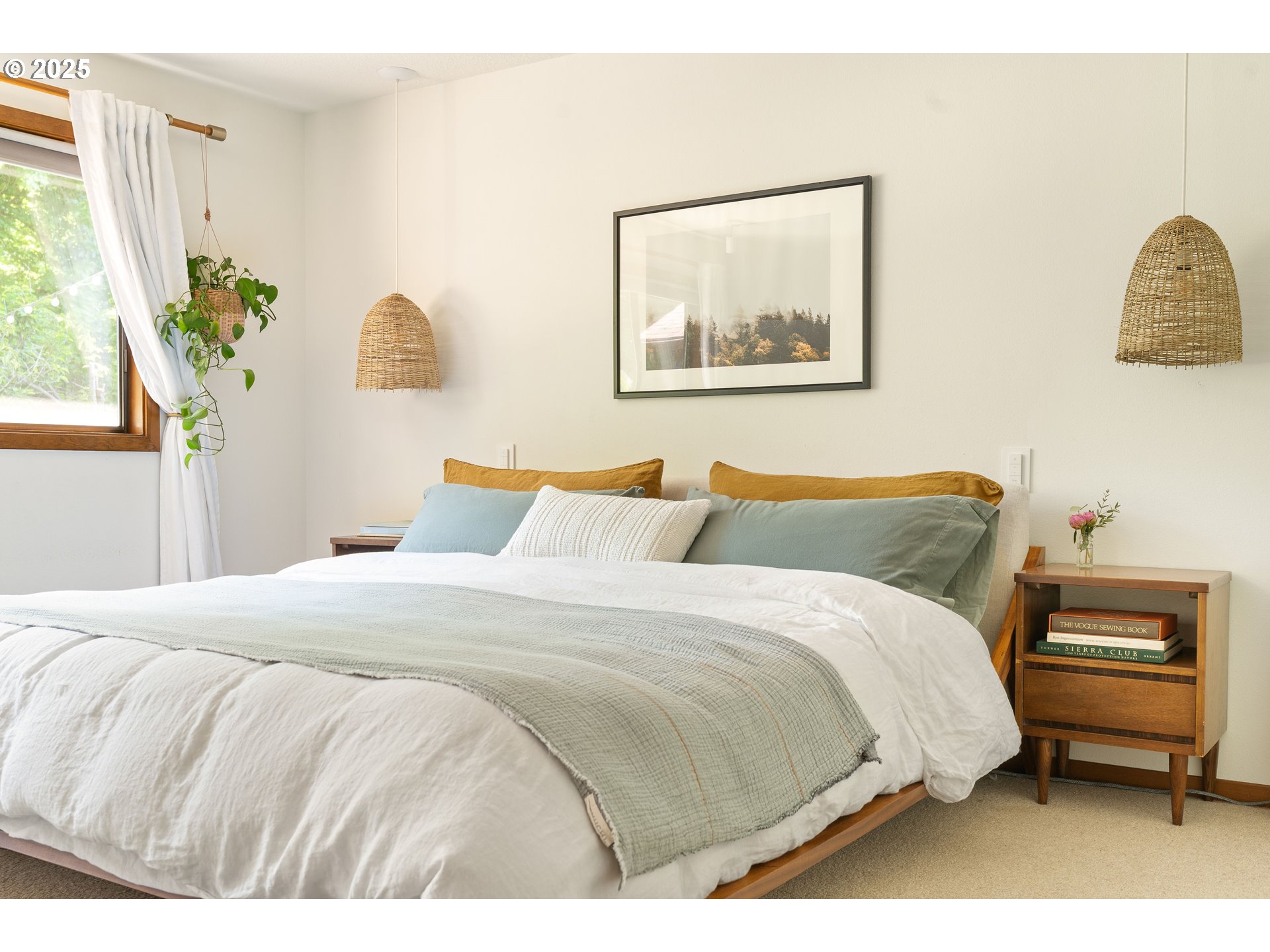 511 Southwest Colony Drive Portland, OR 97219 - Photo 18 of 46 a bedroom with a bed and a painting on the wall