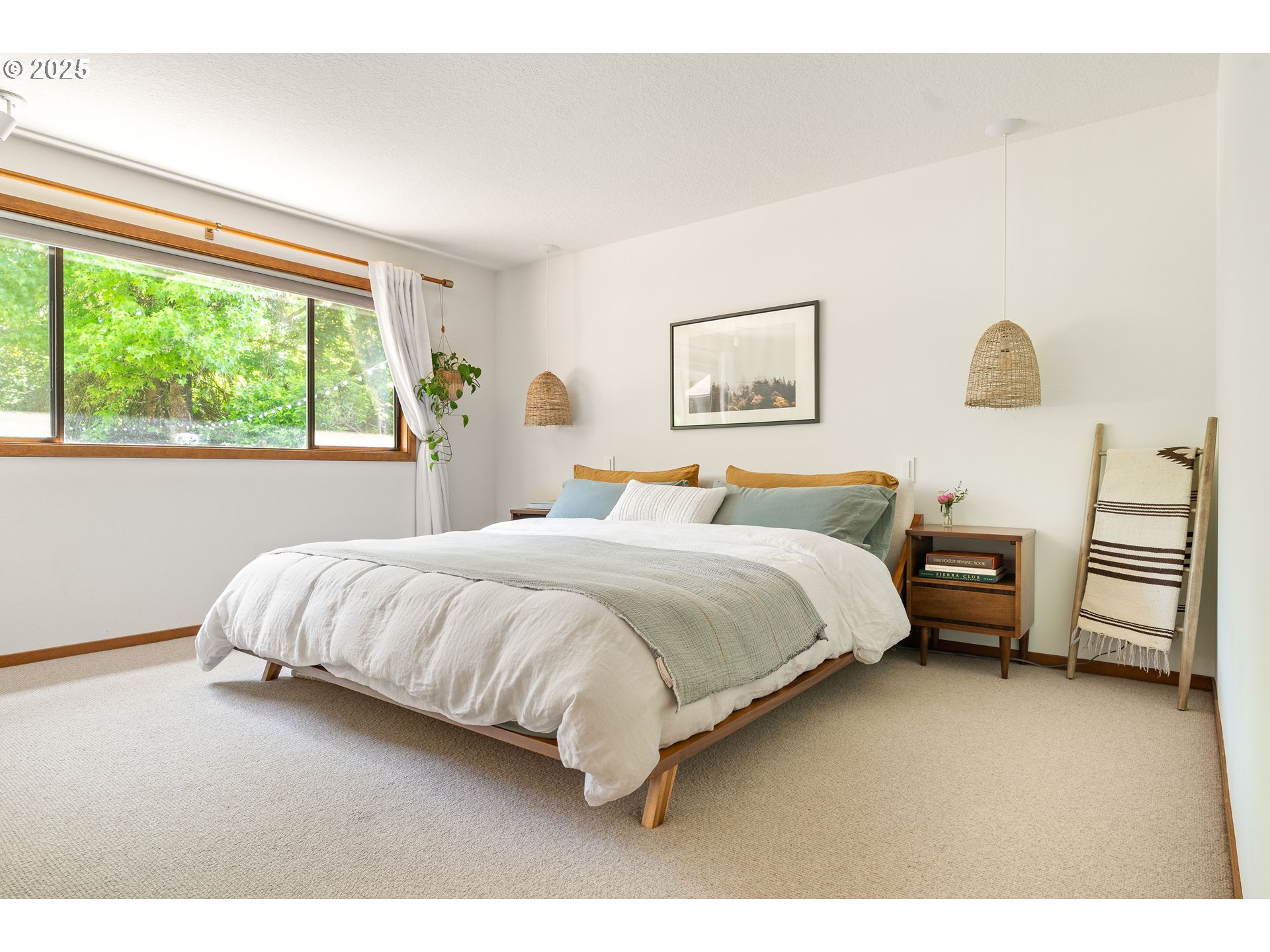 511 Southwest Colony Drive Portland, OR 97219 - Photo 19 of 46 a bedroom with a bed and a painting on the wall