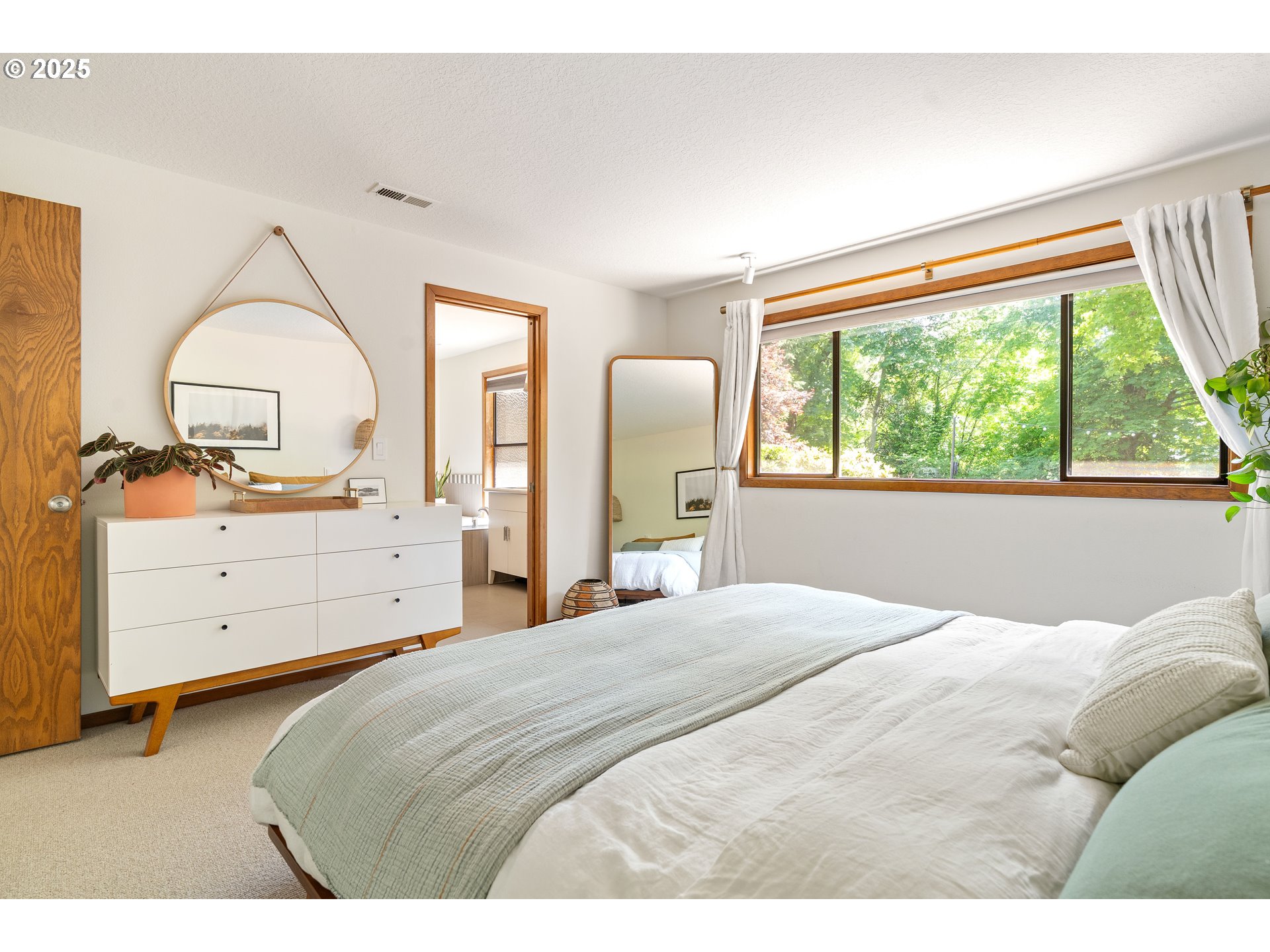 511 Southwest Colony Drive Portland, OR 97219 - Photo 20 of 46 a bedroom with a bed and a dresser