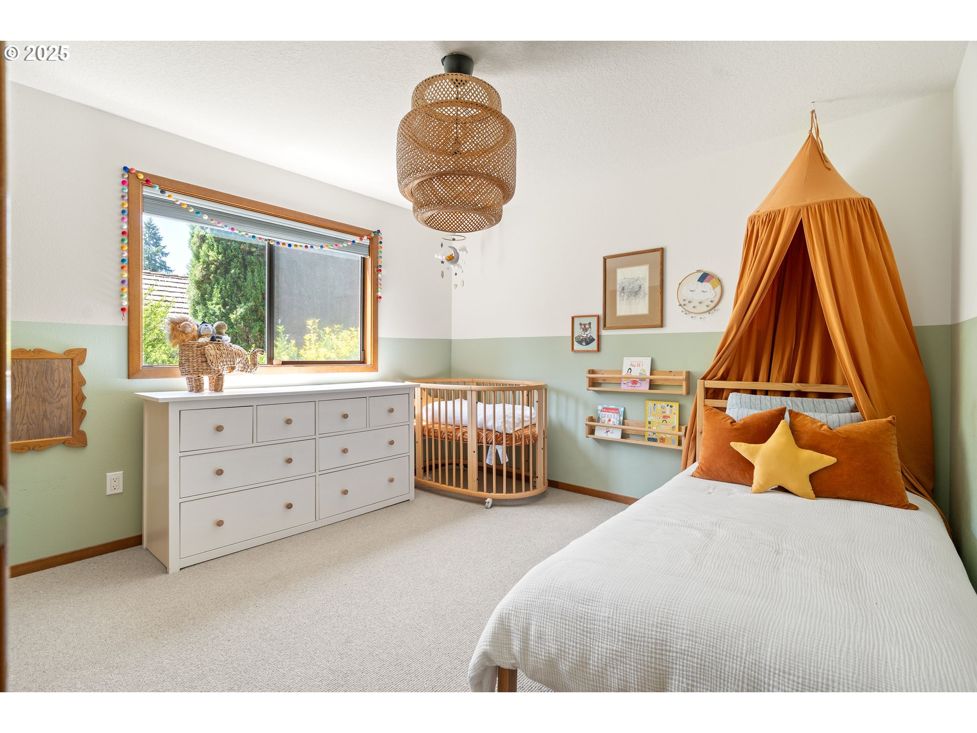 511 Southwest Colony Drive Portland, OR 97219 - Photo 24 of 46 a bedroom with a bed and a chandelier