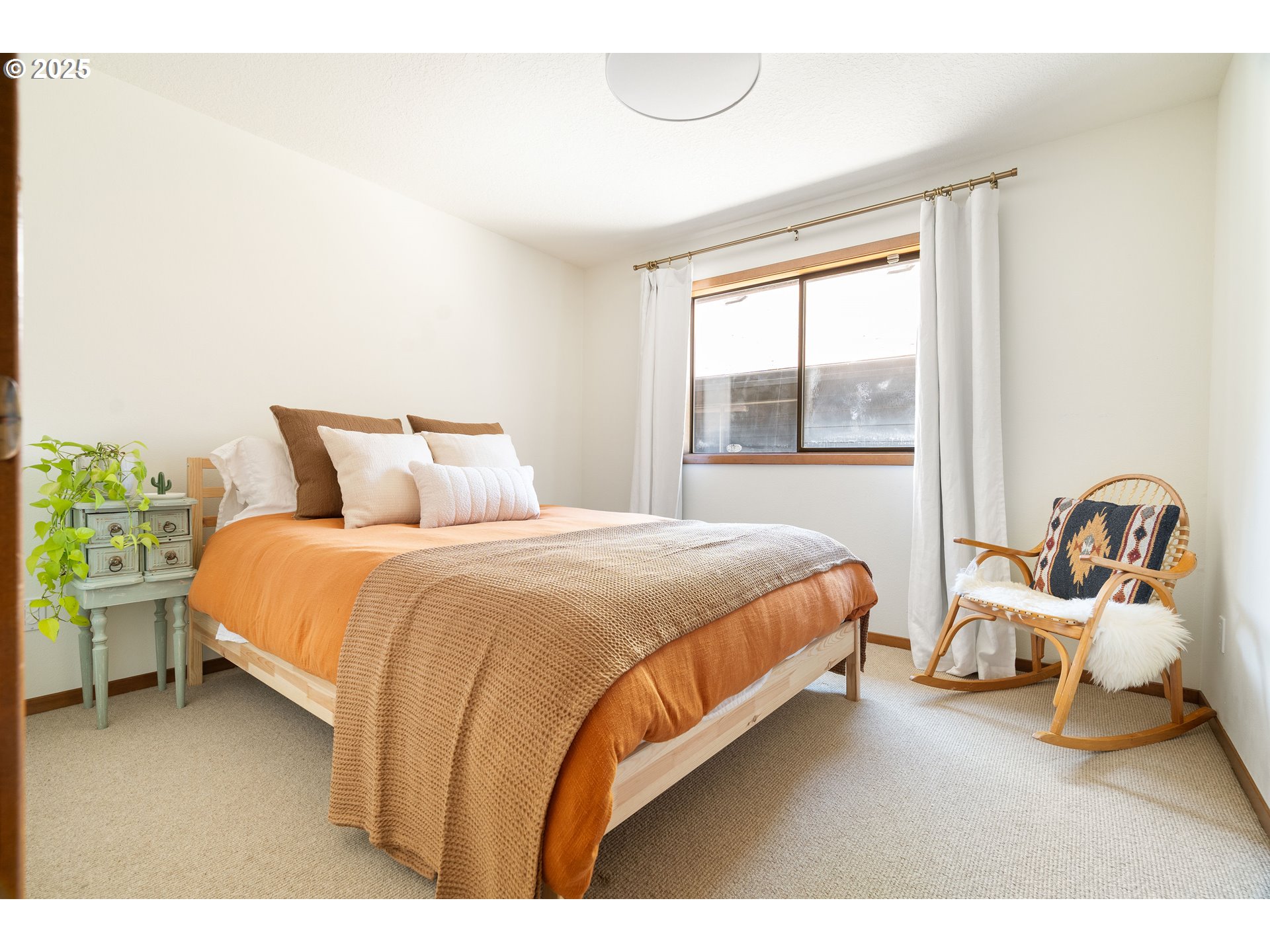 511 Southwest Colony Drive Portland, OR 97219 - Photo 27 of 46 a bedroom with a bed and window
