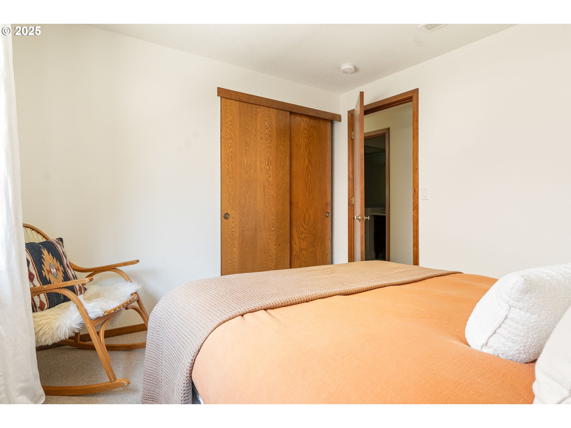 511 Southwest Colony Drive Portland, OR 97219 - Photo 28 of 46 a bedroom with a bed and chair