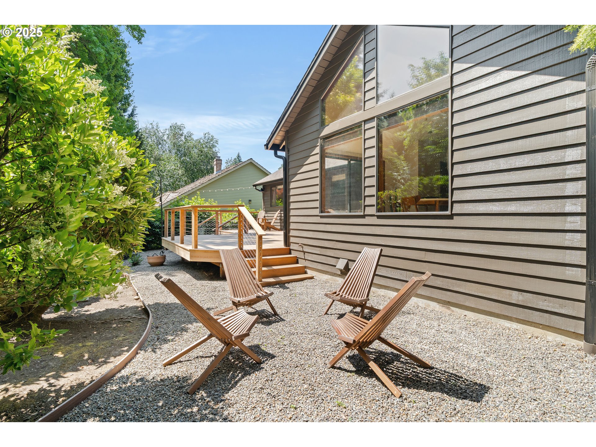 511 Southwest Colony Drive Portland, OR 97219 - Photo 37 of 46 a view of backyard with a table and chairs