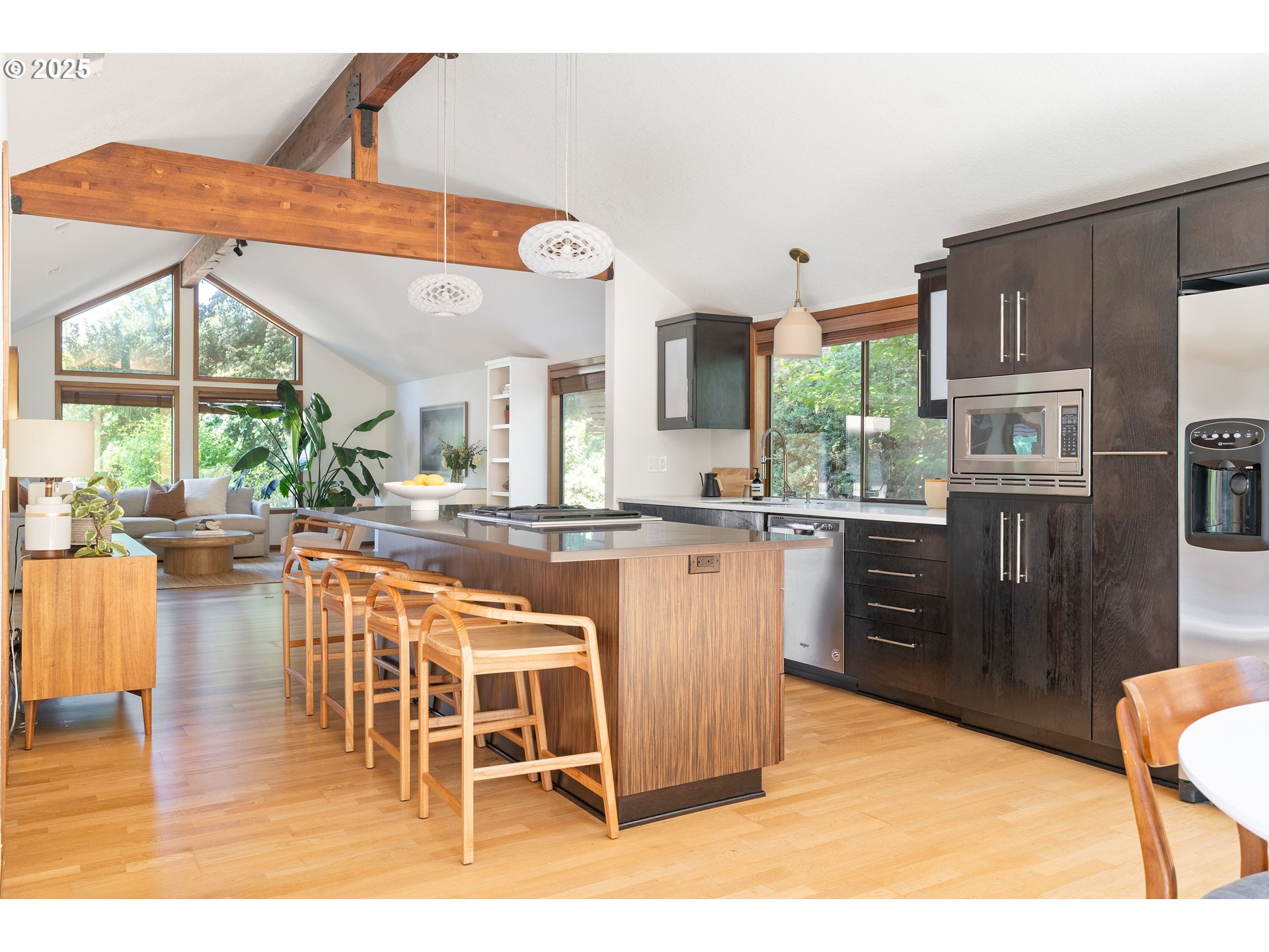 511 Southwest Colony Drive Portland, OR 97219 - Photo 7 of 46 a kitchen with stainless steel appliances kitchen island granite countertop a table and chairs