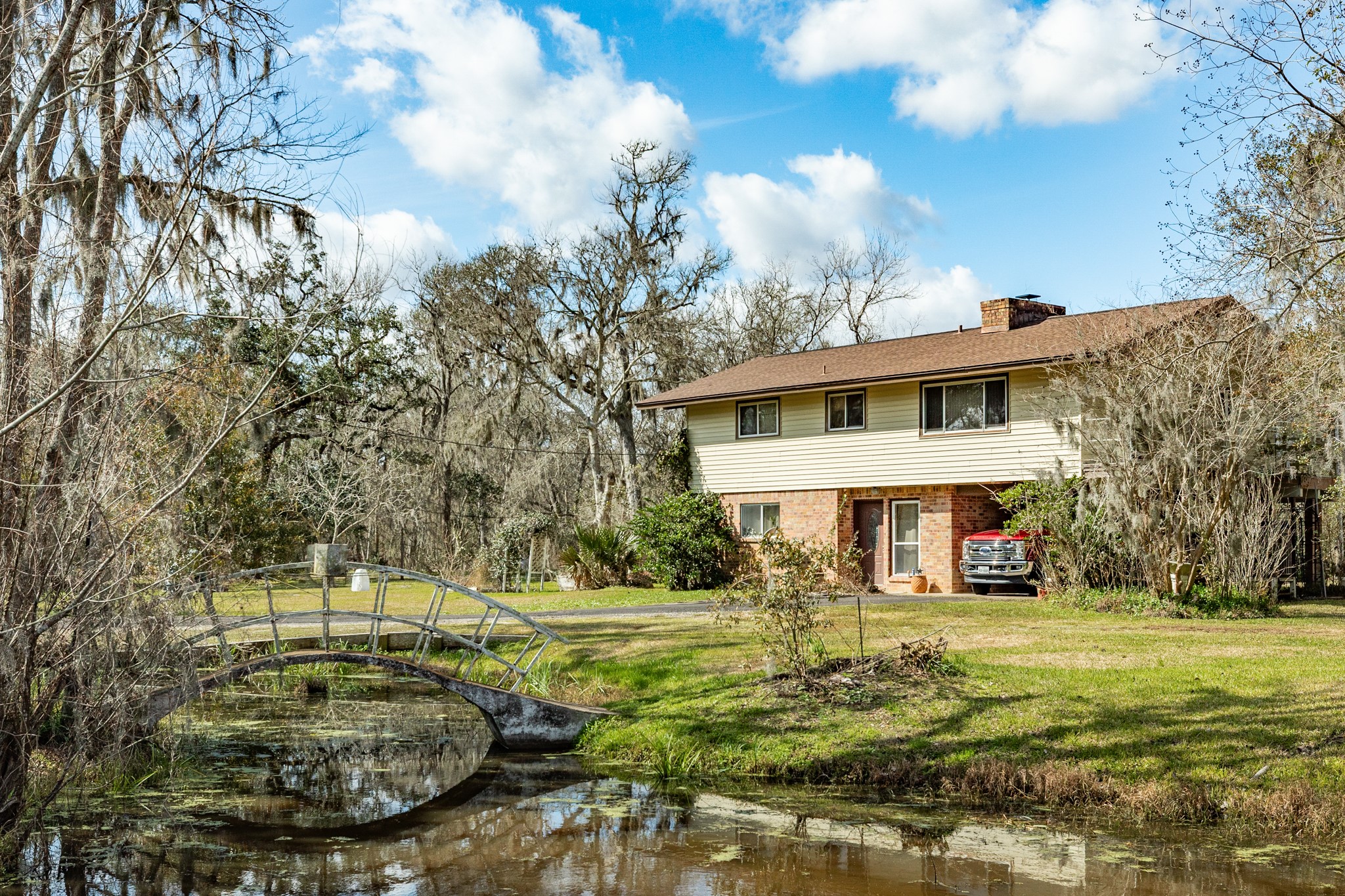703 County Road 605 Angleton, TX 77515 - Photo 1 of 35 a view of a white house with a yard