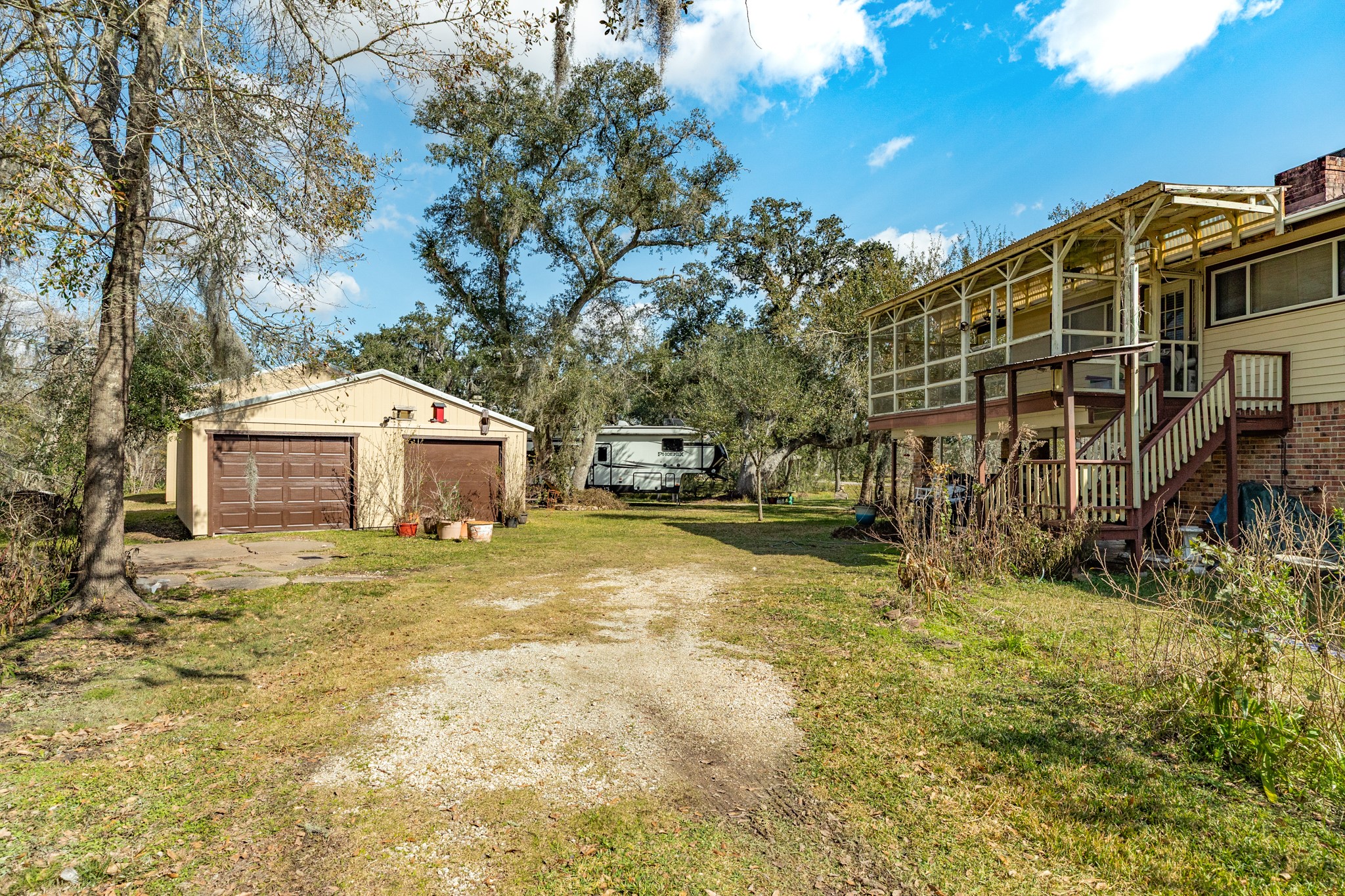 703 County Road 605 Angleton, TX 77515 - Photo 17 of 35 a front view of a house with a yard
