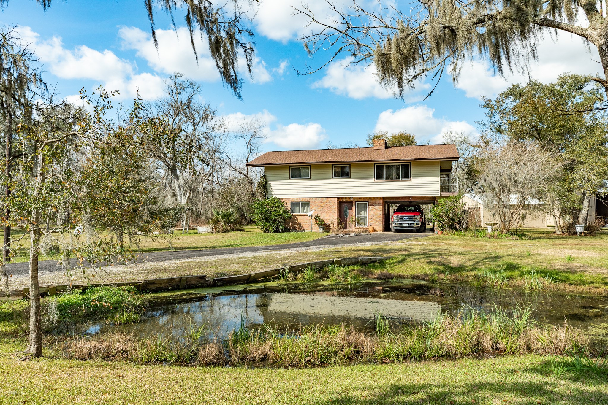 703 County Road 605 Angleton, TX 77515 - Photo 2 of 35 a view of a house with a yard and sitting area