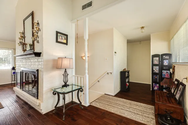 a living room with furniture a fireplace and a chandelier