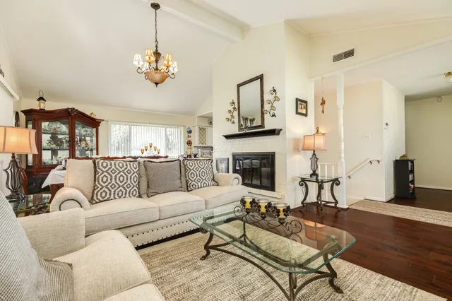 a view of living room with furniture and wooden floor